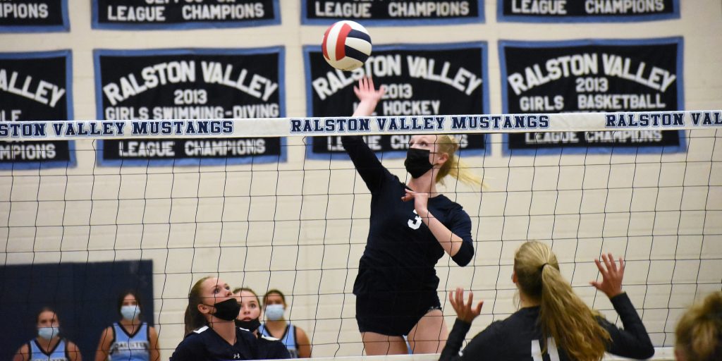 Ralston Valley senior Morgan McChesney (3) puts down a kill during the Mustangs' season opener Friday night against D'Evelyn.