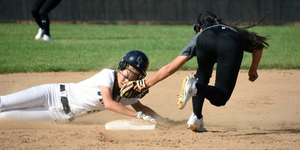 D'Evelyn sophomore Peyton Marvel slides into second base as Pomona senior Madeline Elbert tags Marvel in the face Monday.