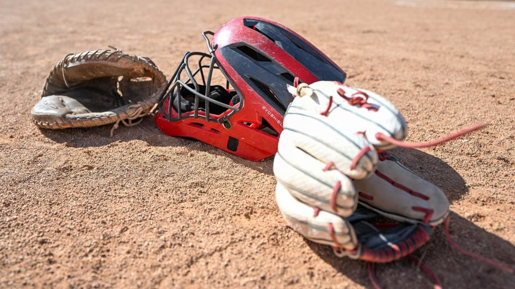 Softball catchers helmet and two gloves