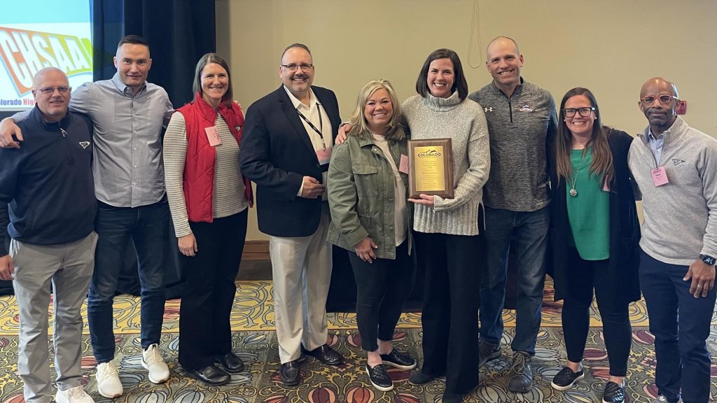 Bethany Brookens with CHSAA staff after winning DEI award