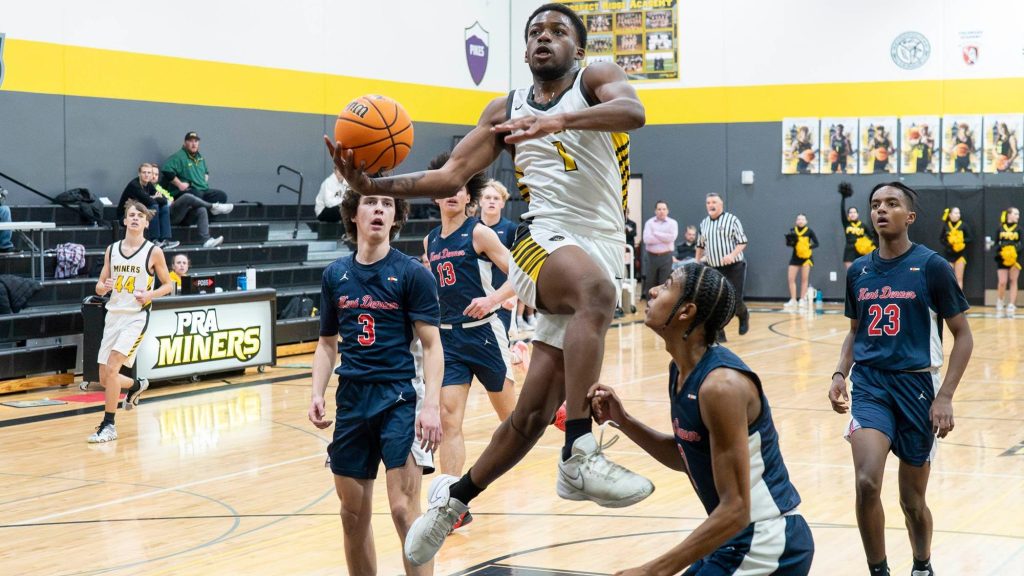 Travis Agbasse of Prospect Ridge Academy flies towards the basketball