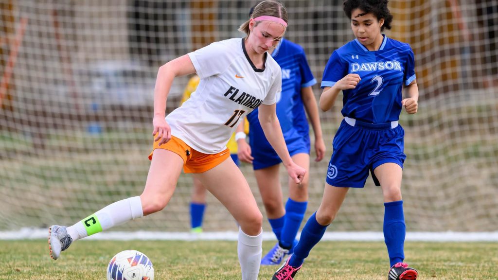 Annabelle Rakers of Flatirons Academy dribbles the ball in front of the goal.