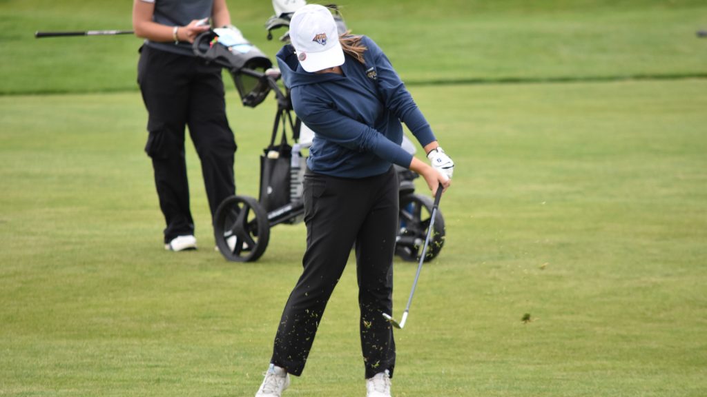 A Holy Family golfer swings