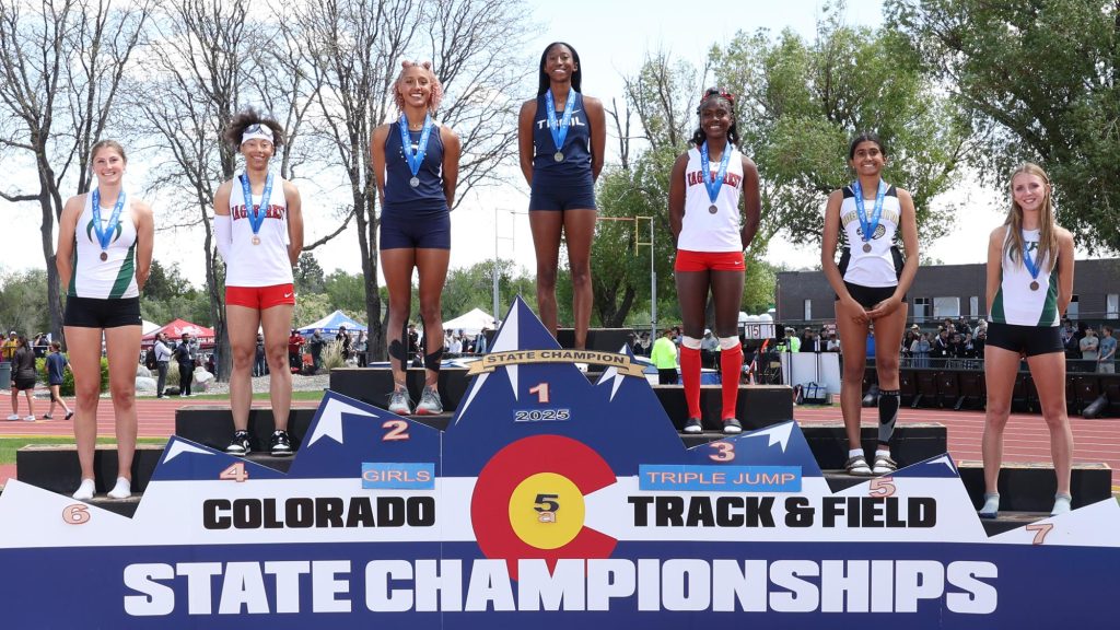 Kaeli Powe of Cherokee Trail on top of the podium after winning the 5A triple jump state championship.