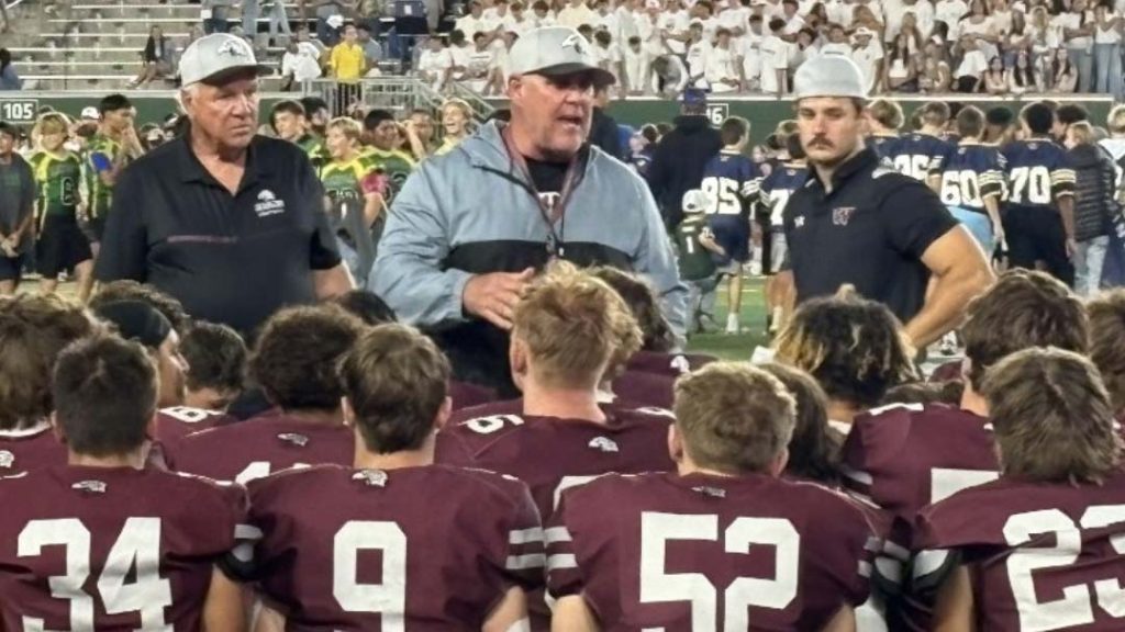 Wellington football coach Travis Peeples talking to his team