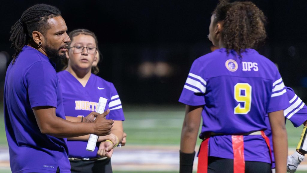 AJ Carter of Denver North talks to members of his Denver North flag football team