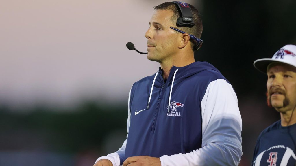 Jeremiah Behrendsen, coaching the Dakota Ridge football team