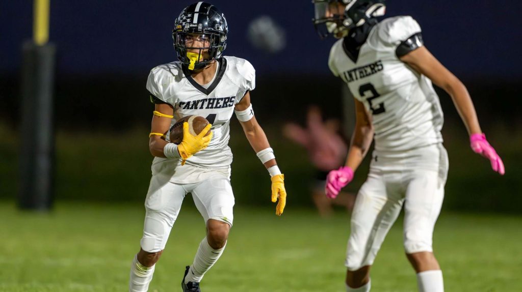 Sierra Grande's Jadyn Martinez runs with the football