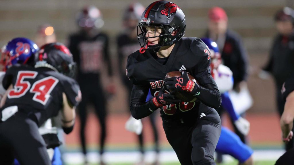 Haxtun's Zach Statz running with the football