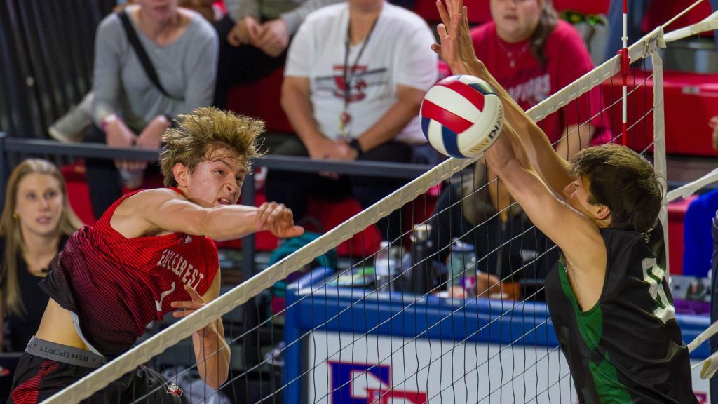 Eaglecrest's Will George follows through on an attack in volleyball